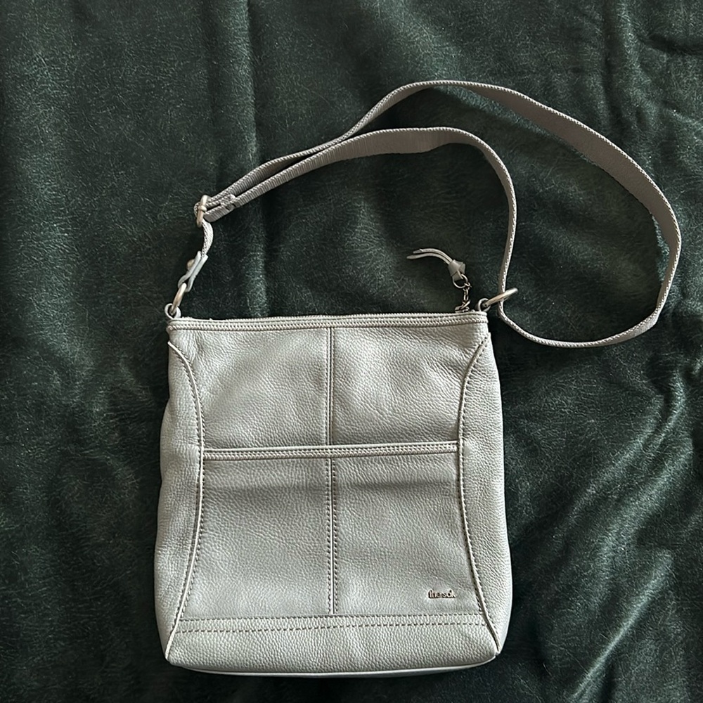 Like new The Sak crossbody bag in grey.